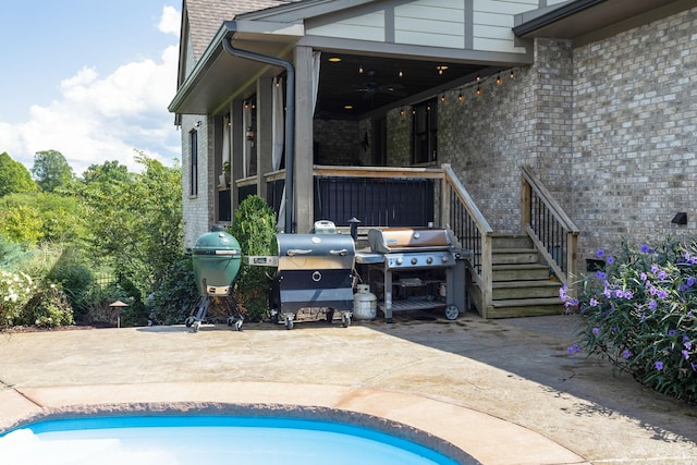 exterior space with ceiling fan, a grill, and a patio area