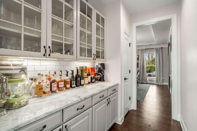 6752 Falls Ridge Ln, College Grove, TN 37046 - bar featuring baseboards, backsplash, and dark wood finished floors