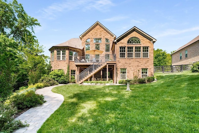 6752 Falls Ridge Ln, College Grove, TN 37046 - back of property with stairway, brick siding, and a deck