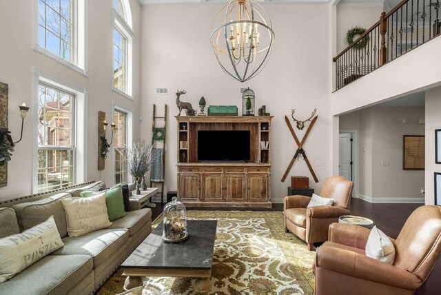 6752 Falls Ridge Ln, College Grove, TN 37046 - living area with a towering ceiling, wood finished floors, a chandelier, and baseboards