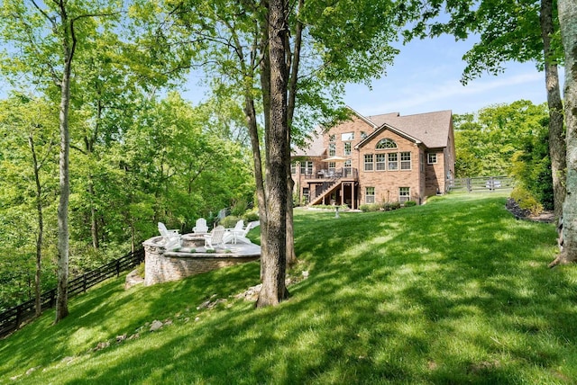 6752 Falls Ridge Ln, College Grove, TN 37046 - rear view of property with a fire pit, stairway, a wooden deck, and brick siding