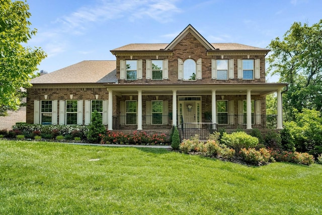 6752 Falls Ridge Ln, College Grove, TN 37046 - view of front of property featuring brick siding, a front lawn, and a porch