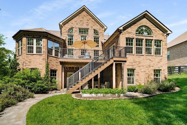 6752 Falls Ridge Ln, College Grove, TN 37046 - back of house with brick siding, stairway, and a wooden deck