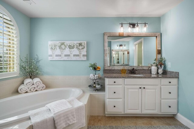 6752 Falls Ridge Ln, College Grove, TN 37046 - bathroom featuring a garden tub, vanity, and tile patterned flooring