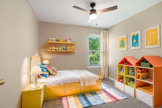 carpeted bedroom with baseboards and ceiling fan