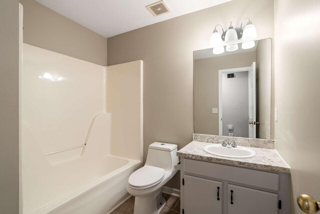 bathroom with toilet, vanity, and shower / tub combination