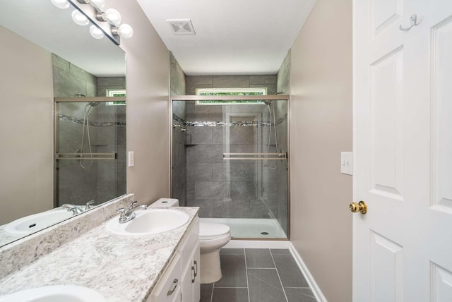 full bathroom featuring tile patterned floors, double vanity, a stall shower, toilet, and baseboards