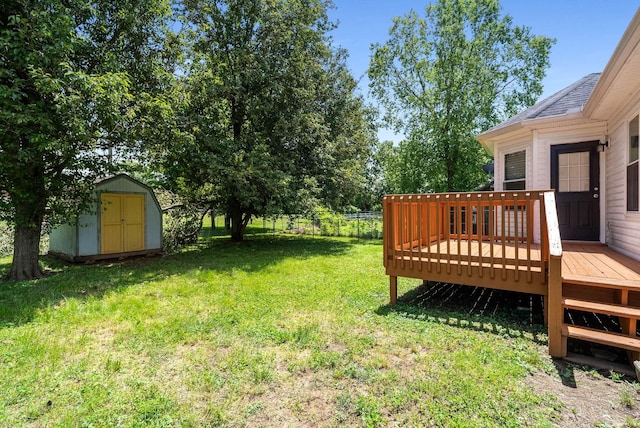 view of yard featuring a storage unit, a wooden deck, and an outbuilding