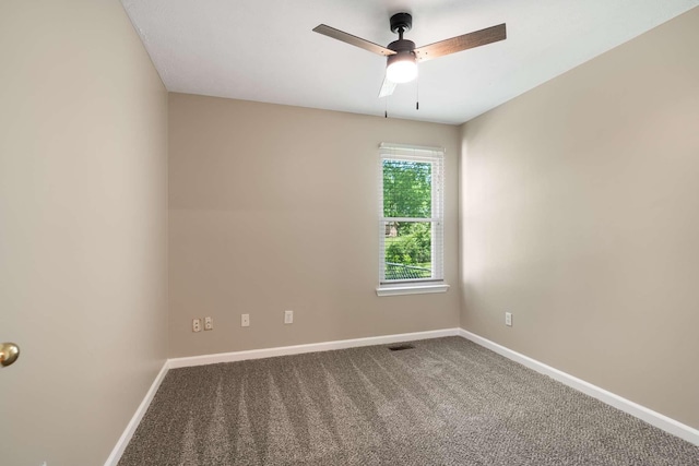 carpeted spare room with baseboards and ceiling fan