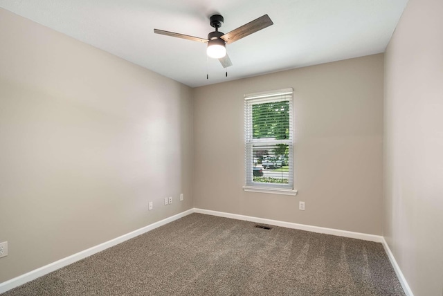 spare room featuring carpet, baseboards, and a ceiling fan