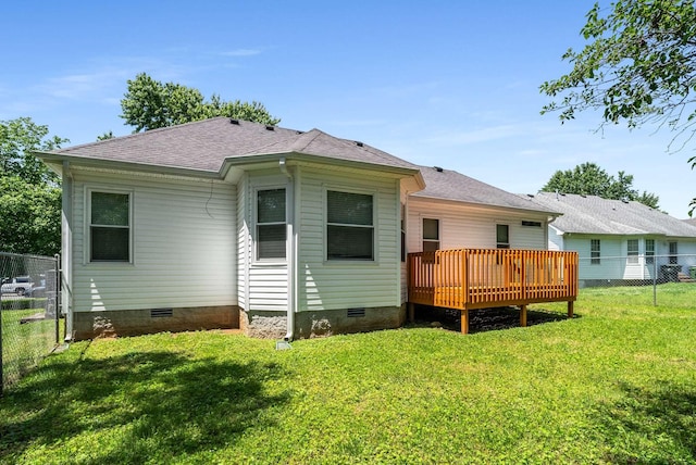 rear view of property with a deck, crawl space, and roof with shingles