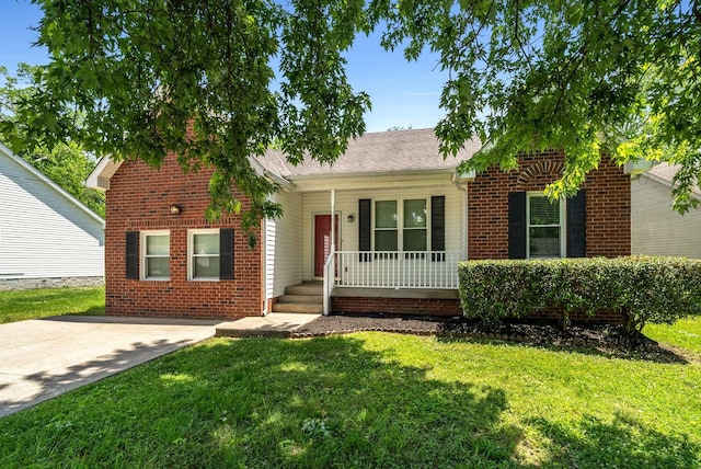 view of front of home with covered porch, a front yard, and brick siding