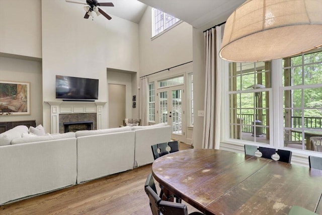 2507 Eagle Creek Way, Signal Mountain, TN 37377 - dining area with wood finished floors, a ceiling fan, a fireplace, french doors, and high vaulted ceiling