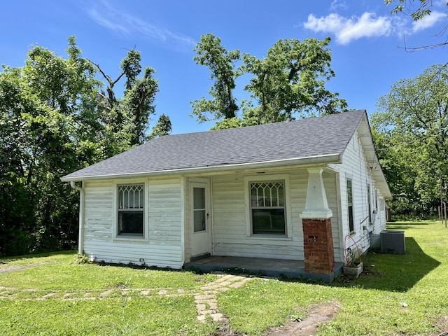 1538 Neelys Bend Rd, Madison, TN 37115 - view of front of house with a shingled roof, a front yard, and central AC