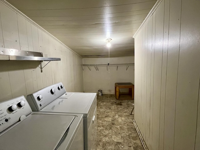1538 Neelys Bend Rd, Madison, TN 37115 - clothes washing area featuring washing machine and dryer, wood walls, and stone finish flooring