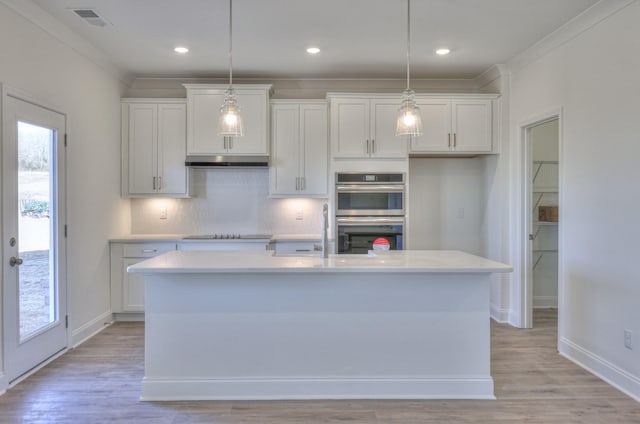 2269 Triple Crown Cir, Gallatin, TN 37066 - kitchen featuring double oven, under cabinet range hood, light countertops, white cabinetry, and ornamental molding