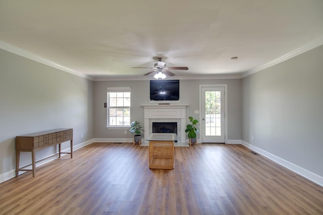 1334 Davy Crockett Dr, Murfreesboro, TN 37129 - unfurnished living room featuring healthy amount of natural light, a fireplace, a ceiling fan, wood finished floors, and crown molding