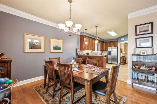 7100 Dale Ridge Rd Unit A4, Lancaster, TN 38569 - dining room featuring a chandelier, ornamental molding, baseboards, and light wood-style floors