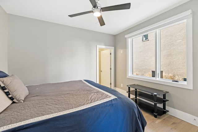 1242 2nd Ave S Unit 4, Nashville, TN 37210 - bedroom featuring wood finished floors, multiple windows, baseboards, and ceiling fan