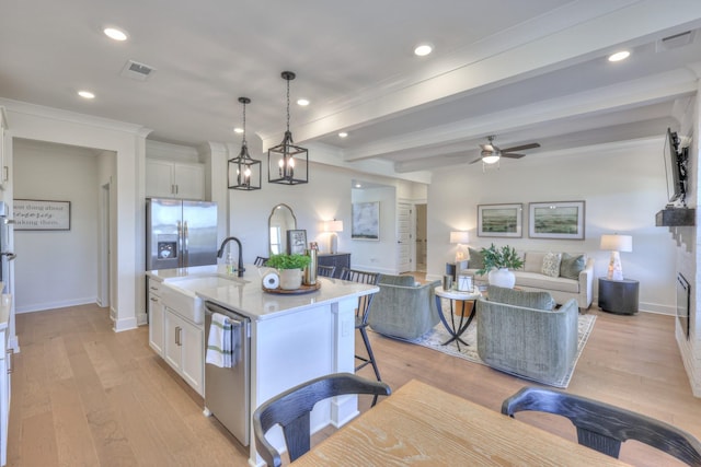 460 Triple Crown Cir, Gallatin, TN 37066 - kitchen with stainless steel appliances, a sink, open floor plan, white cabinets, and recessed lighting