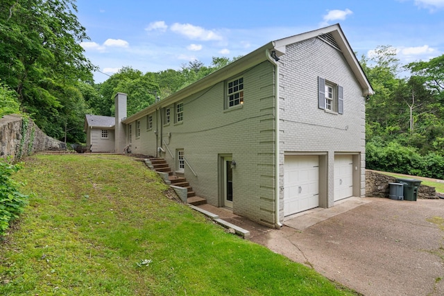 5175 Granny White Pike, Nashville, TN 37220 - view of side of home with a garage, brick siding, driveway, and a lawn