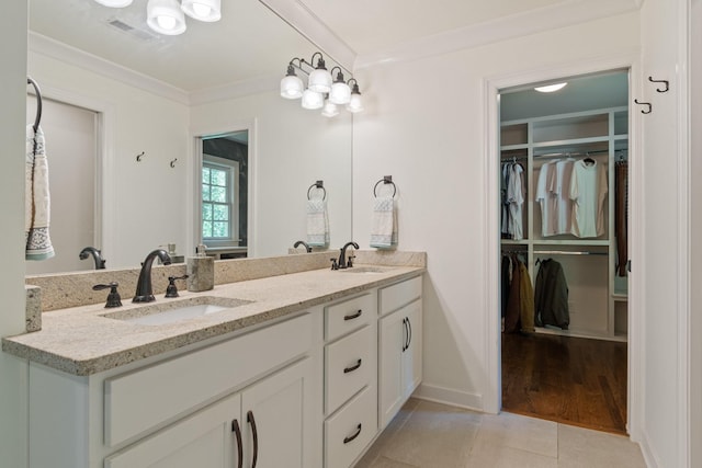 5175 Granny White Pike, Nashville, TN 37220 - bathroom featuring a walk in closet, ornamental molding, double vanity, tile patterned flooring, and baseboards