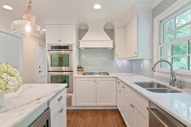 5175 Granny White Pike, Nashville, TN 37220 - kitchen featuring custom exhaust hood, a sink, appliances with stainless steel finishes, decorative backsplash, and white cabinetry