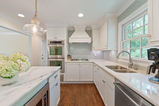 5175 Granny White Pike, Nashville, TN 37220 - kitchen with custom range hood, appliances with stainless steel finishes, a sink, ornamental molding, and white cabinets