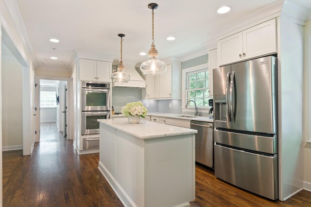 5175 Granny White Pike, Nashville, TN 37220 - kitchen featuring stainless steel appliances, ornamental molding, a kitchen island, white cabinetry, and backsplash