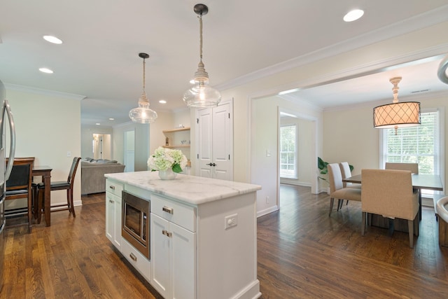 5175 Granny White Pike, Nashville, TN 37220 - kitchen with stainless steel microwave, white cabinetry, a kitchen island, decorative light fixtures, and dark wood-style flooring