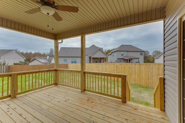 wooden terrace with a ceiling fan and a residential view