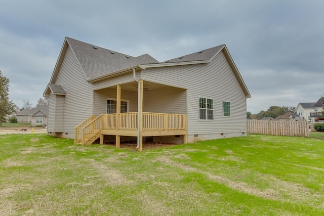 back of property with crawl space, a deck, and roof with shingles