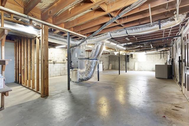 basement with washer / dryer and concrete block wall