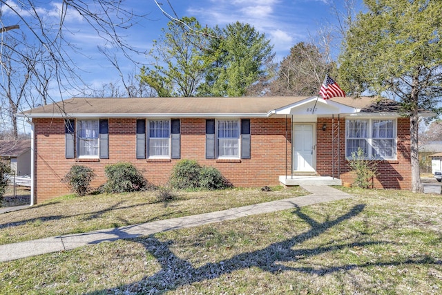 ranch-style house with brick siding and a front yard