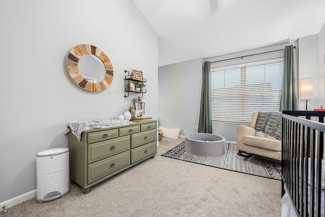 bedroom with light colored carpet, baseboards, and vaulted ceiling