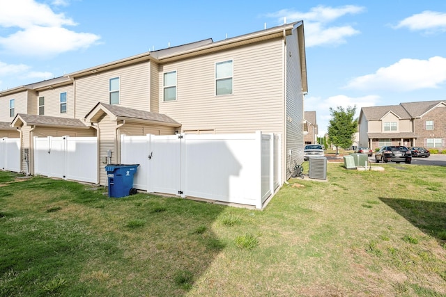rear view of property featuring a residential view and central AC unit