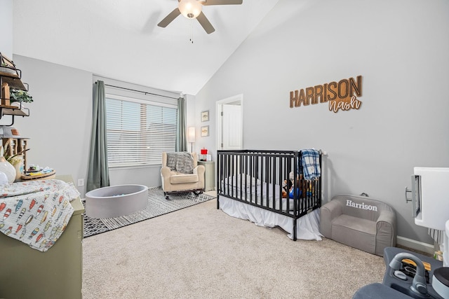 carpeted bedroom featuring a ceiling fan, high vaulted ceiling, baseboards, and a nursery area