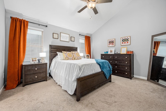 bedroom featuring light carpet, baseboards, high vaulted ceiling, and ceiling fan