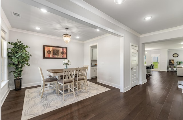 1149 Brixworth Dr, Spring Hill, TN 37174 - dining area with crown molding, dark wood-style flooring, baseboards, recessed lighting, and a chandelier
