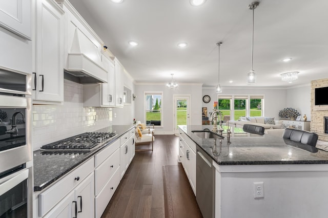 1149 Brixworth Dr, Spring Hill, TN 37174 - kitchen with a sink, stainless steel appliances, crown molding, dark stone counters, and dark wood-style floors
