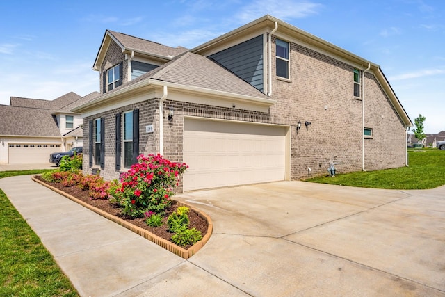 1149 Brixworth Dr, Spring Hill, TN 37174 - view of property exterior featuring concrete driveway, brick siding, and a shingled roof