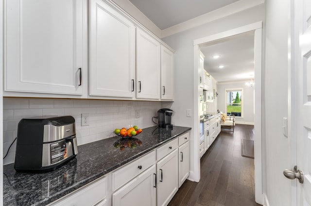 1149 Brixworth Dr, Spring Hill, TN 37174 - kitchen with white cabinetry, dark wood-type flooring, backsplash, dark stone counters, and stainless steel gas cooktop