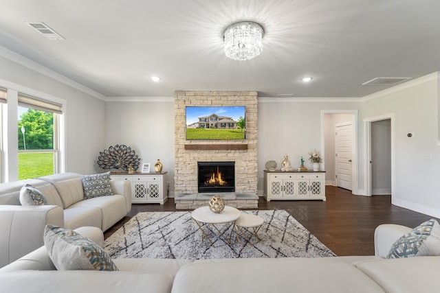 1149 Brixworth Dr, Spring Hill, TN 37174 - living room featuring crown molding, dark wood-type flooring, a stone fireplace, a chandelier, and baseboards