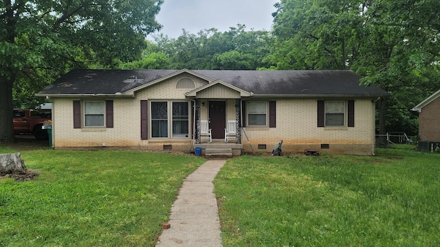 single story home with crawl space, brick siding, a front yard, and a shingled roof