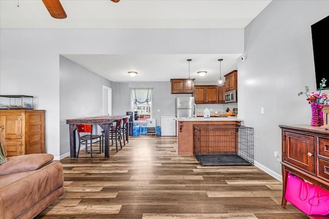 890 Akersville Rd, Lafayette, TN 37083 - kitchen featuring stainless steel appliances, a peninsula, dark wood-type flooring, and baseboards