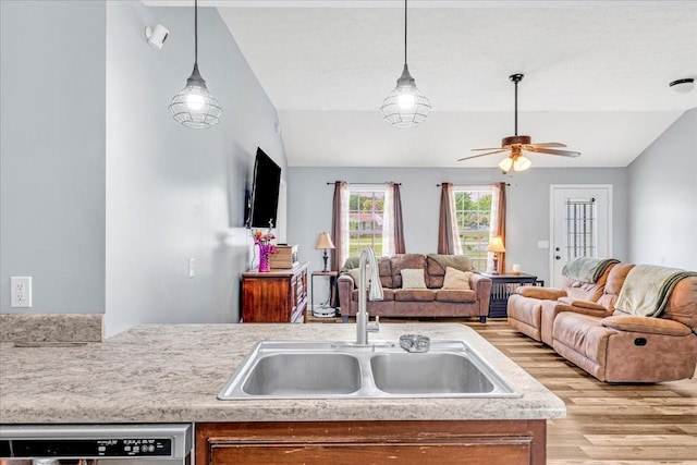 890 Akersville Rd, Lafayette, TN 37083 - kitchen featuring a sink, light wood-style floors, vaulted ceiling, dishwashing machine, and ceiling fan