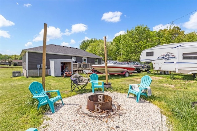 890 Akersville Rd, Lafayette, TN 37083 - view of grassy yard featuring an outdoor fire pit and cooling unit