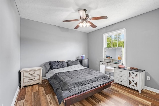 890 Akersville Rd, Lafayette, TN 37083 - bedroom featuring wood finished floors, baseboards, ceiling fan, and a textured ceiling