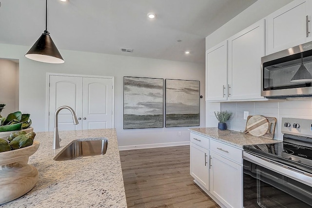 284 Subban Ct, Lebanon, TN 37087 - kitchen featuring stainless steel appliances, a sink, white cabinetry, wood finished floors, and tasteful backsplash