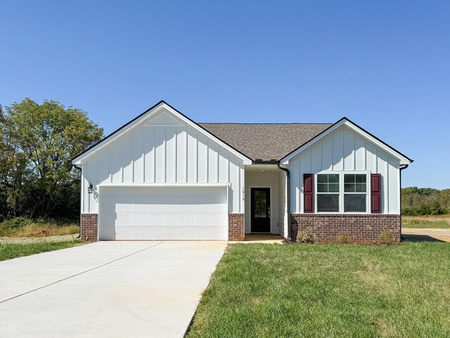 284 Subban Ct, Lebanon, TN 37087 - view of front facade with brick siding, a garage, driveway, board and batten siding, and a front yard